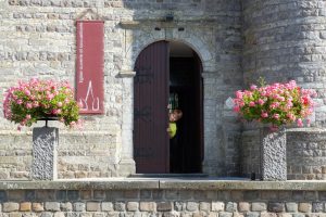 photo d'une porte d'église ouverte avec un enfant qui pointe le bout de son nez à travers la porte.