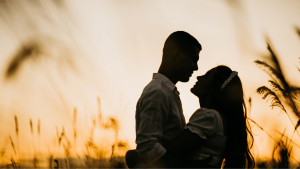 Photo d'un couple enlacé sur fond de soleil couchant